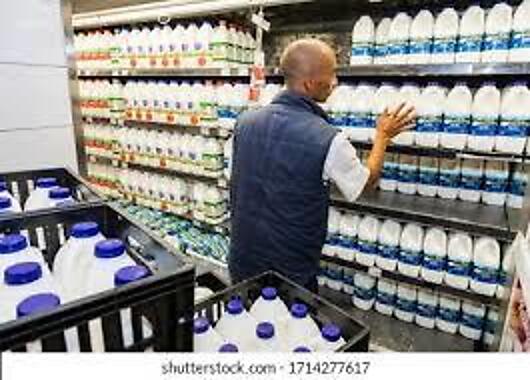 Retail merchandiser stocking shelves